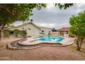 Backyard features a sparkling pool, diving board, cabana, and mature trees at 3938 E Gable Ave, Mesa, AZ 85206