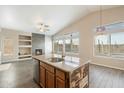 Charming kitchen island featuring granite counters and a rustic wood base design at 40504 N Territory Trl, Anthem, AZ 85086