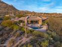 Exterior aerial view of desert home with large pool and patio, set in natural desert landscape at 42237 N 107Th Pl, Scottsdale, AZ 85262