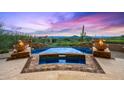 Outdoor pool featuring desert landscaping, fire bowls, and breathtaking mountain scenery at 42237 N 107Th Pl, Scottsdale, AZ 85262