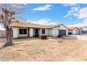 Inviting single-story house with a cozy front yard under a clear sky at 4401 W Lewis Ave, Phoenix, AZ 85035