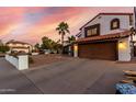 Charming two-story home with a red tile roof, two car garage, and a low maintenance desert landscape at 5761 E Tierra Buena Ln, Scottsdale, AZ 85254