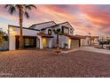 Charming two-story home with a fountain, red tile roof, and desert landscape in the front yard at 5761 E Tierra Buena Ln, Scottsdale, AZ 85254