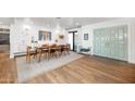 Stylish dining room with modern light fixture, a beautiful wooden dining table and stylish light blue doors at 5801 N 22Nd Pl, Phoenix, AZ 85016