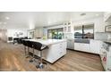 Bright and airy kitchen boasting a large island with seating, stainless steel appliances, and modern cabinetry at 5801 N 22Nd Pl, Phoenix, AZ 85016