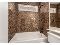Modern bathroom with textured tile surround and updated fixtures, offering a spa-like retreat at 5808 E Brown Rd # 110, Mesa, AZ 85205