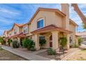 Quaint townhouse featuring a red tile roof, cozy porch, and desert-friendly landscaping at 5808 E Brown Rd # 110, Mesa, AZ 85205