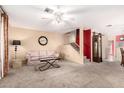 Spacious living room with plush carpet, neutral walls, and a staircase in view at 5808 E Brown Rd # 110, Mesa, AZ 85205