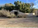 Charming walled entry to the property with mature trees and desert landscaping at 6242 E Maverick Rd, Paradise Valley, AZ 85253