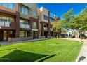 Attractive condo building featuring manicured lawn and inviting curb appeal at 6605 N 93Rd Ave # 1024, Glendale, AZ 85305