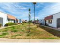 Community street featuring townhouses with red tile roofs and desert landscaping at 6812 N 35Th Ave # G, Phoenix, AZ 85017