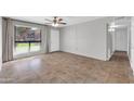 Bright living room with tile flooring, a ceiling fan, and large windows for ample natural light at 7110 E Continental Dr # 1031, Scottsdale, AZ 85257