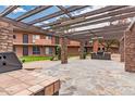 Outdoor patio area featuring stone columns and a built-in BBQ grill for social gatherings at 7110 E Continental Dr # 1031, Scottsdale, AZ 85257