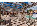 Poolside patio area, featuring a pergola, barbecue, and view of the pool at 7110 E Continental Dr # 1031, Scottsdale, AZ 85257