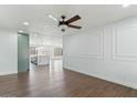 Bright living room with hardwood floors, ceiling fan, and decorative wall trim at 739 E Glade Ave, Mesa, AZ 85204