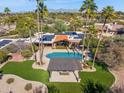 Aerial view of this home featuring a stunning pool, outdoor lounge area, and solar panels at 8008 N 66Th St, Paradise Valley, AZ 85253