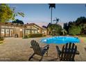 Inviting outdoor pool area with lounge chairs, a covered patio, and verdant landscaping perfect for entertaining at 8008 N 66Th St, Paradise Valley, AZ 85253