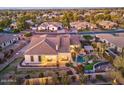 Aerial view of a beautiful home with a lush backyard, swimming pool and mature landscaping at 815 E County Down Dr, Chandler, AZ 85249