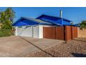 This home features a side view of the garage, with a wood gate leading to the back yard at 8626 E San Miguel E Ave, Scottsdale, AZ 85250