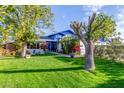 Lovely home featuring a well-manicured front lawn, colorful flowerbeds, and cozy seating area at 8626 E San Miguel E Ave, Scottsdale, AZ 85250