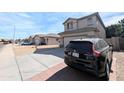 View of a street with several homes with driveways and xeriscaped front yards at 8861 W Paradise Dr, Peoria, AZ 85345