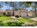 Charming home featuring a well-manicured lawn, a two-car garage, and desert landscaping at 9115 W Kimberly Way, Peoria, AZ 85382