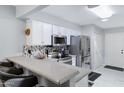 Bright kitchen with stainless appliances, quartz countertops, and sleek white cabinets at 9115 W Kimberly Way, Peoria, AZ 85382