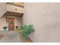 Charming front door with a decorative wreath and beautiful landscaping adding to the property's allure at 9460 N 92Nd St # 119, Scottsdale, AZ 85258