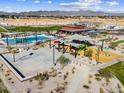 Aerial view showcasing a basketball court, a swimming pool, a playground, and desert landscaping at 116 N 176Th Ln, Goodyear, AZ 85338