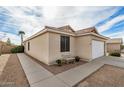 Side exterior view with neutral stucco, desert landscaping, and covered front porch at 1165 W 4Th Ave, Apache Junction, AZ 85120