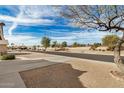 Street view of a well-maintained neighborhood with desert landscaping at 1165 W 4Th Ave, Apache Junction, AZ 85120