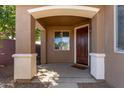 Welcoming covered front porch with decorative columns, a wood door, and a 'Welcome' mat at 119 W Leatherwood Ave, San Tan Valley, AZ 85140