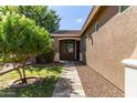 Inviting entrance with a landscaped front yard and a paved walkway to the front door at 119 W Leatherwood Ave, San Tan Valley, AZ 85140