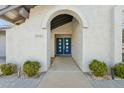 Close-up of the home's entrance featuring a striking blue double door with modern windows at 11942 N 95Th St, Scottsdale, AZ 85260