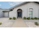Stunning home featuring a xeriscaped front yard and an arched entryway at 11942 N 95Th St, Scottsdale, AZ 85260