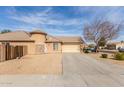 Attractive single-Gathering home with desert landscaping, a tile roof, and a large driveway with an attached garage at 12312 N 147Th Ln, Surprise, AZ 85379