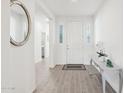 Bright and airy foyer with wood flooring, a white front door, and stylish decor at 14325 W Faye Way, Surprise, AZ 85387