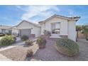 Charming single-story home featuring desert landscaping, a gray garage door, and picturesque front yard at 14325 W Faye Way, Surprise, AZ 85387