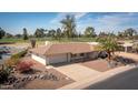 Charming single-story home boasts a two-car garage and manicured landscaping at 15602 N Nicklaus Ln, Sun City, AZ 85351