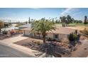 Inviting home with desert landscape, two-car garage, and well-maintained front yard at 15602 N Nicklaus Ln, Sun City, AZ 85351