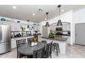 Bright kitchen featuring stainless steel appliances, an island, and a dining area, ideal for everyday meals and gatherings at 17632 W Voltaire St, Surprise, AZ 85388