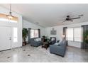 Inviting living room with neutral tones, stylish furniture, plenty of natural light, and tiled floors for easy maintenance at 17632 W Voltaire St, Surprise, AZ 85388