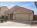 Charming single-story home featuring a two-car garage, desert landscaping, and a brick-lined walkway at 18637 W Fulton St, Goodyear, AZ 85338