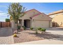 Charming single-story home featuring a two-car garage, desert landscaping, and a brick-lined walkway at 18637 W Fulton St, Goodyear, AZ 85338