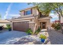 Inviting two-story home with a two-car garage and well-maintained landscaping at 1899 W Prospector Way, San Tan Valley, AZ 85144