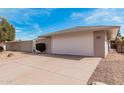 The exterior of a well-maintained home, highlighting a spacious two-car garage with a clean, modern design at 19817 N Ponderosa Cir, Sun City, AZ 85373