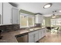 Bright kitchen featuring granite countertops, white cabinets, stainless steel appliances, and a dining nook at 2129 N Apollo Ct, Chandler, AZ 85224