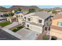 Inviting two-story home with a well-maintained lawn, concrete driveway, and tasteful exterior color scheme at 23510 N 25Th St, Phoenix, AZ 85024