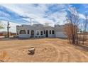 Charming gray desert home with Southwestern architecture, desert landscaping and a two-car garage at 28214 N 223Rd Ln, Wittmann, AZ 85361