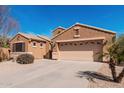 A well-maintained single-story home featuring a two-car garage and desert landscaping at 29247 N Bauxite Ln, San Tan Valley, AZ 85143